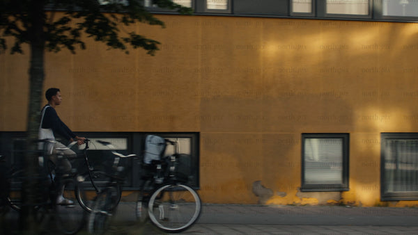 Young man cycles through Luleå on a sunny summer day