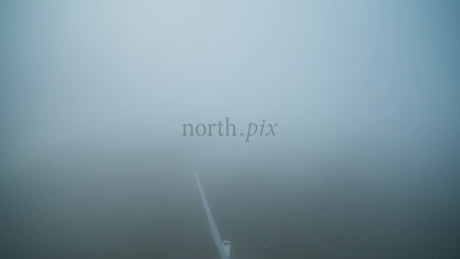 Wind Turbine Emerging from Fog: Aerial View of Renewable Energy in Haraholmen