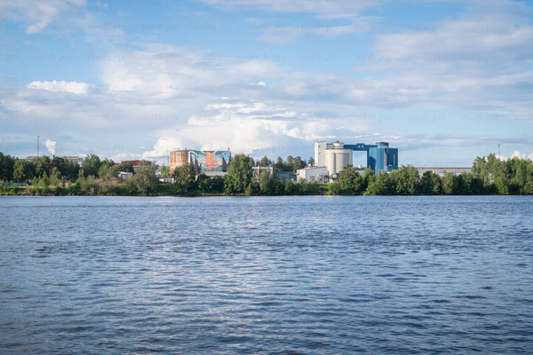 Industrial complex on riverbank in summer afternoon