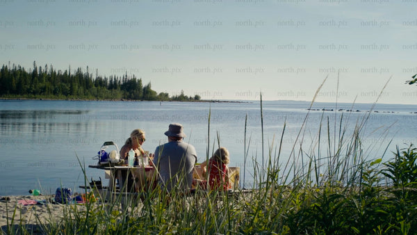 Summer family picnic on the shores of Luleå