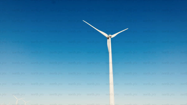 Wind turbine rotating in Markbygden, Sweden: Winter drone view of renewable energy