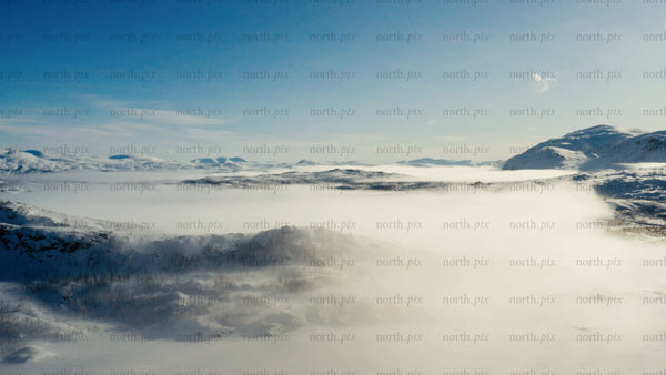 Riksgränsen: Aerial view of winter landscape with snow and clouds