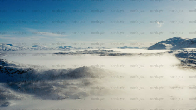 Riksgränsen: Aerial view of winter landscape with snow and clouds
