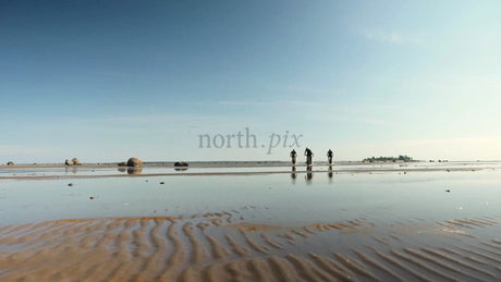 Group Fat Biking on Wet Sand at Sandön Archipelago Beach in Luleå, Sweden