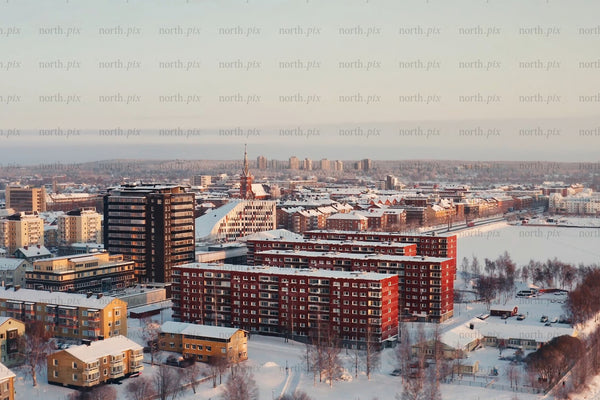 Snowy Luleå city center aerial view of modern red and brown buildings in winter
