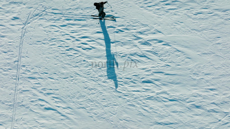 Skier Carving Down Snowy Slope on Sunny Winter Day, Riksgransen, Sweden