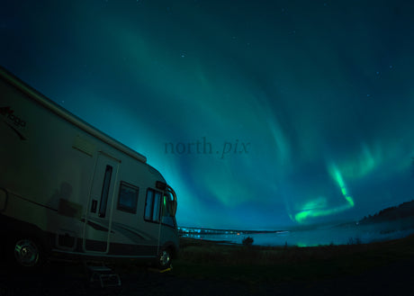 Northern Lights Over RV in Lulea Nighttime Winter Landscape