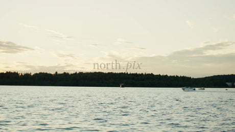 Sunset Over the Lulea River: Motorboats Sailing on a Summer Evening in Sweden