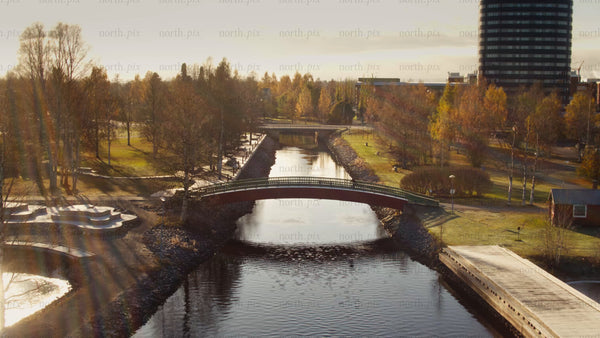 Aerial view of Piteå city park in autumn featuring a bridge over a canal
