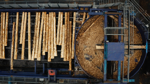 Aerial view of log debarking process in lumber mill