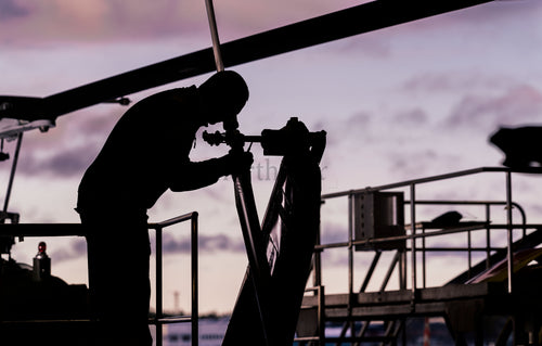 Helicopter maintenance worker at sunset