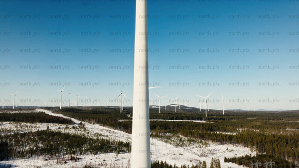 Aerial view of wind turbines in snowy winter landscape at Markbygden