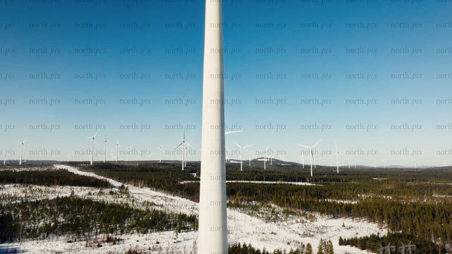 Aerial view of wind turbines in snowy winter landscape at Markbygden