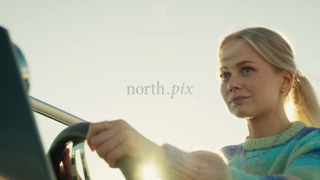 Woman Steering Boat at Sunset in the Luleå Archipelago, Sweden