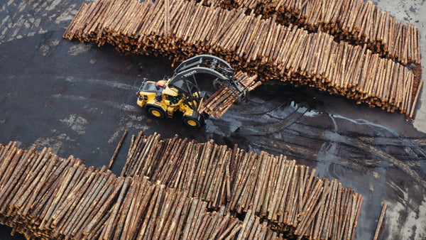 Aerial view of log organization with Volvo l180h at lumber yard
