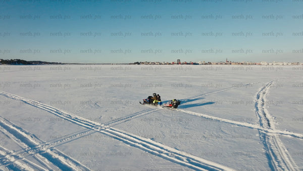 Snowmobile ride across frozen lake in Luleå: Winter wonderland adventure