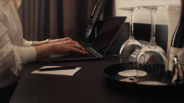 Businesswoman working on her laptop in a modern hotel room