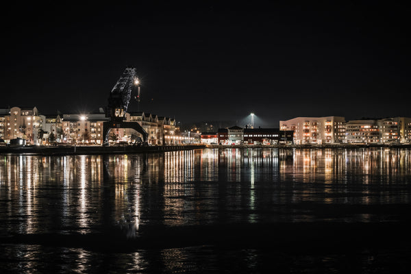 Luleå south harbor waterfront with crane and reflected building Lights