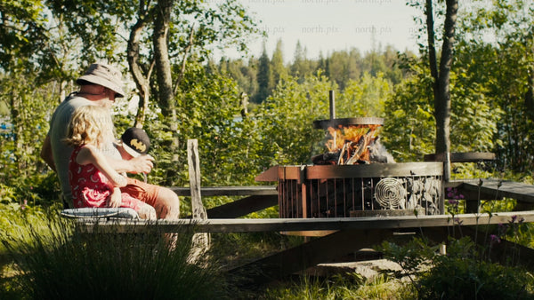 Family summer day by the fire pit in Kluntarna archipelago, Luleå