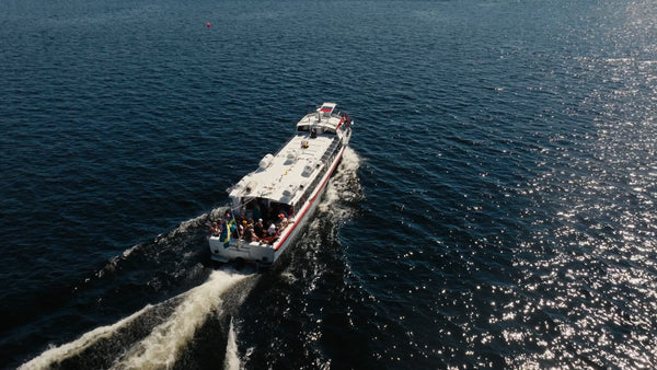 Tour boat on the Luleälven in Luleå, on a summer day, aerial drone view