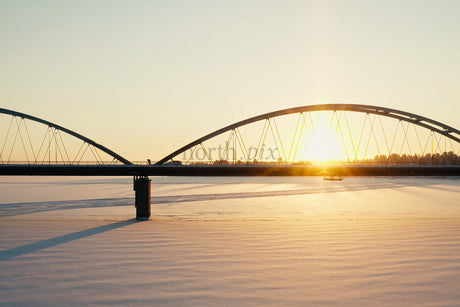 Sunset Over Snowy River With Modern Arch Bridge In Luleå City Center