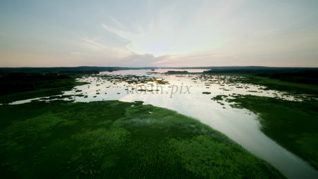 Serene Sunset Over Calm Lake: Aerial View of Summer Landscape