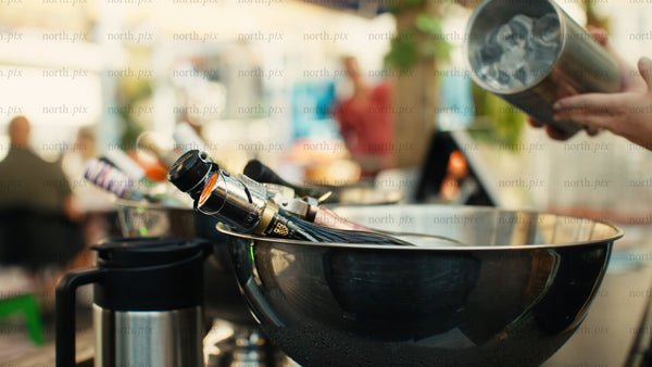 Cooling drinks in ice bucket at an outdoor summer party in Luleå