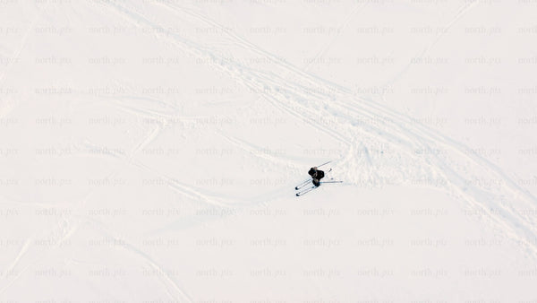 Aerial view of skiing downhill on snowy slope in riksgransen