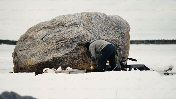 Winter in the Luleå archipelago: Man by fire on frozen lake