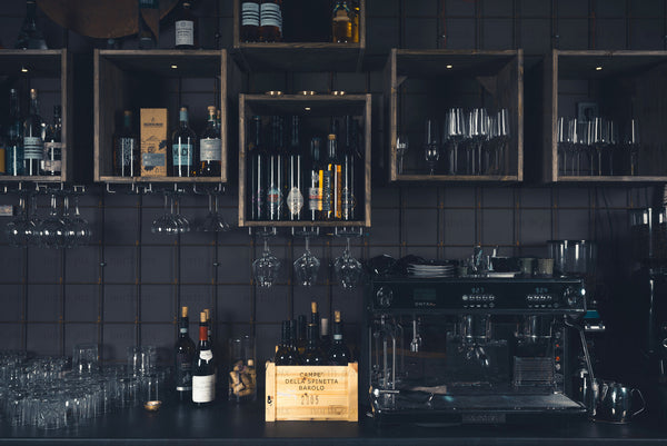 Bar counter with wine bottles and espresso machine, interior