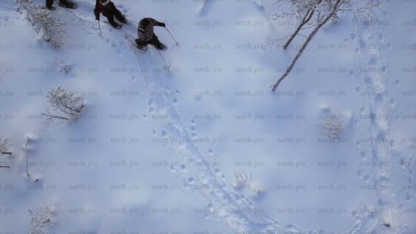 Friends snowshoeing through a winter wonderland in Gunnarsbyn