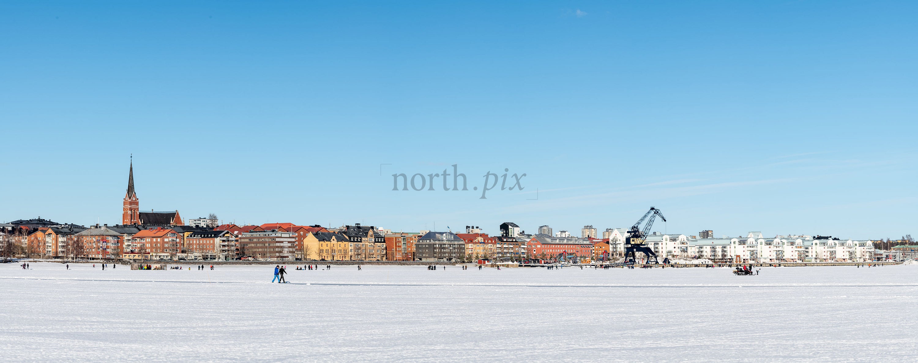 Town skyline with frozen bay in winter daytime