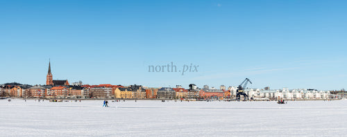 Town skyline with frozen bay in winter daytime