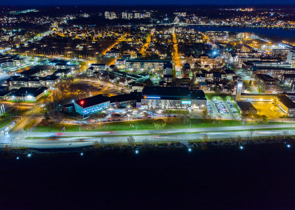 Drone aerial view of Luleå at night during blue hour in autumn
