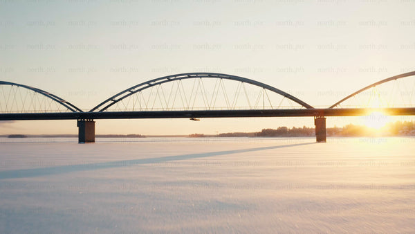 Winter sunset over bridge in Luleå: Aerial drone footage