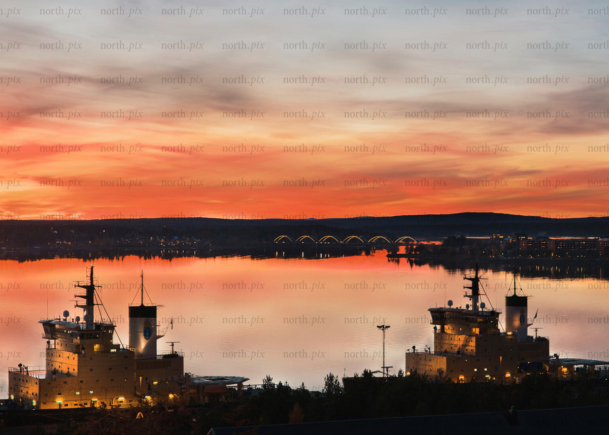 Sunset view of ships and bridge in Luleå harbor during autumn