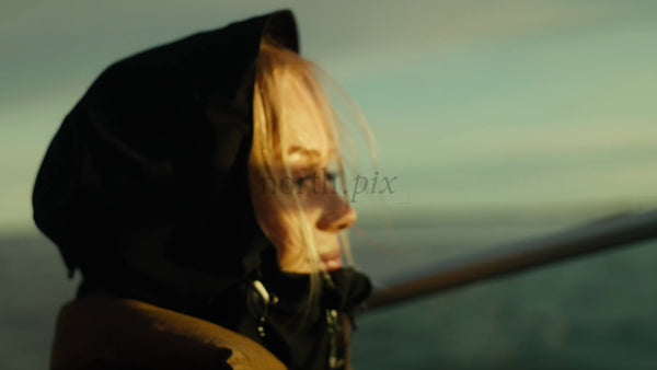 Woman on Scenic Boat Trip in Luleå Archipelago During Golden Hour