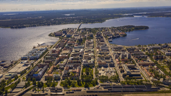 Aerial summer day timelapse of Luleå: Cityscape, river, and boats