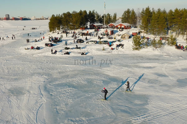 Winter Fun At Luleå City Center: Skaters And Snowy Gatherings On A Frozen Lake