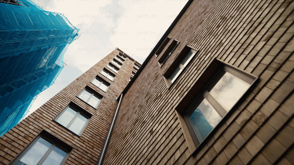 Modern wood architecture: High-rise building facade and windows with scaffolding