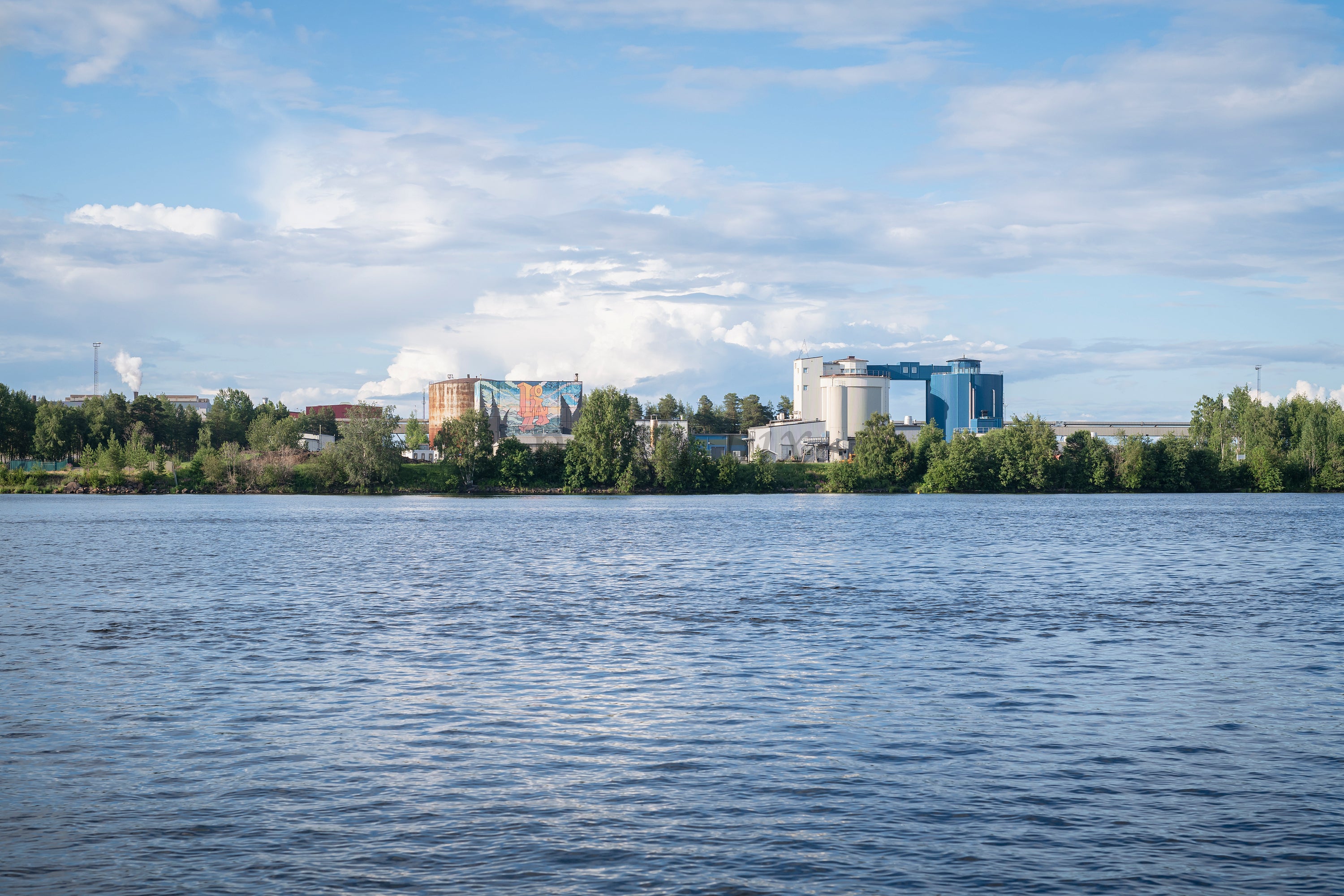 Industrial complex on riverbank in summer afternoon