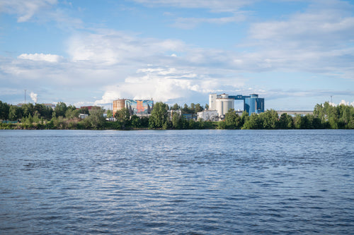 Industrial complex on riverbank in summer afternoon