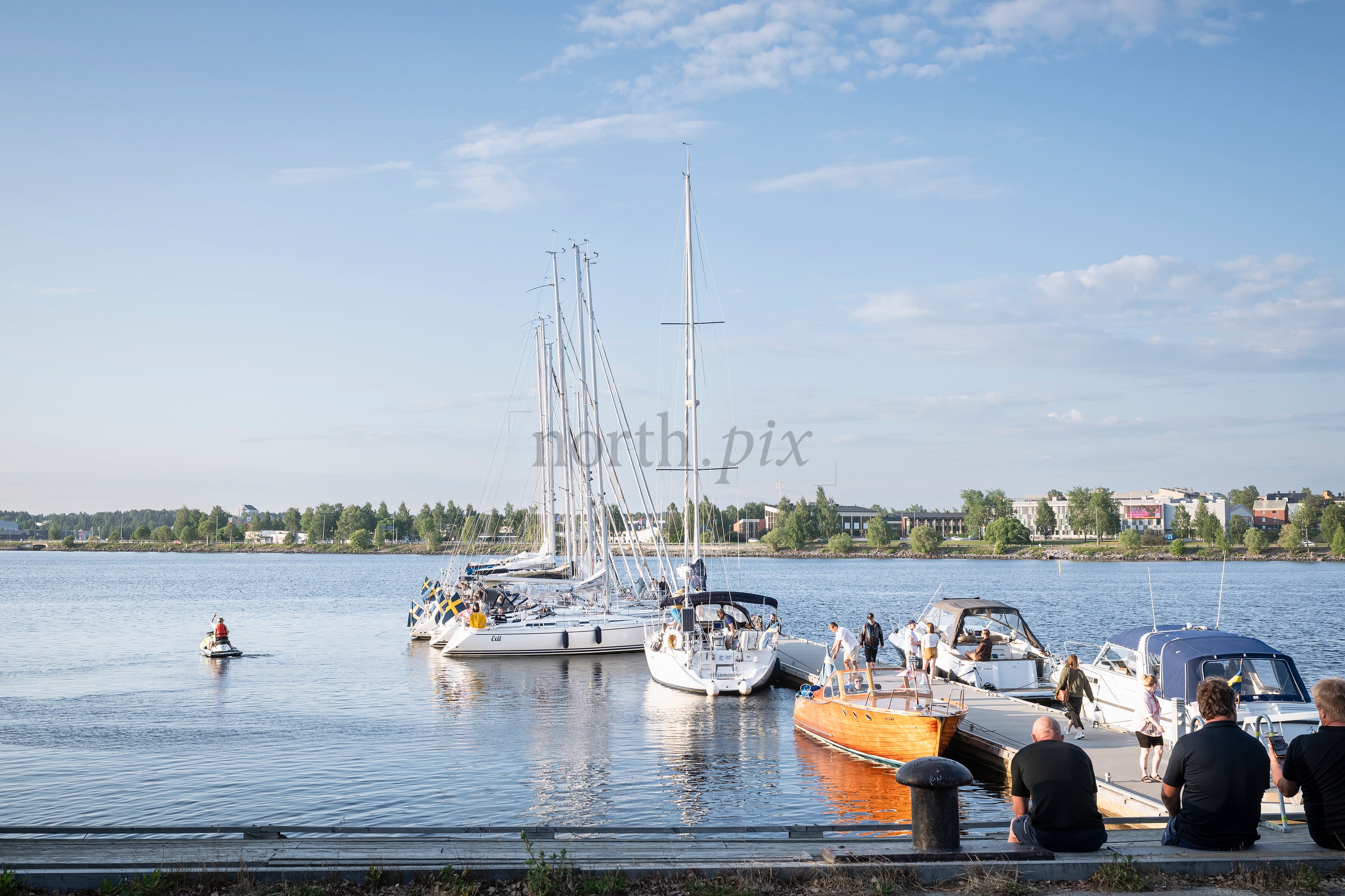Sailboats and motorboats at a harbor in summer afternoon