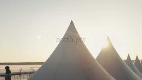 Winter Sunset Over Event Tents on Frozen Waterfront in Luleå, Sweden