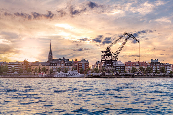 Luleå south harbor waterfront with industrial crane at sunset