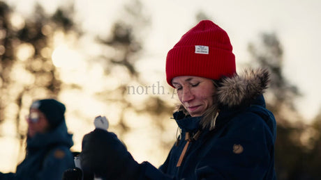 Woman Preparing for Skiing in Golden Hour Winter Forest, Luleå Archipelago, Sweden