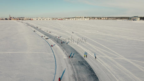 Winter in Luleå: Aerial View of People Enjoying a Frozen River on a Sunny Day