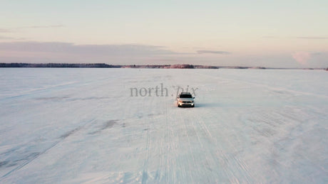 Driving on Frozen Ice Road in Luleå Archipelago at Sunset