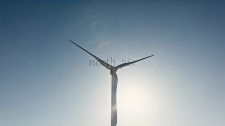Rotating Wind Turbine Against Blue Sky, Clean Energy Generation