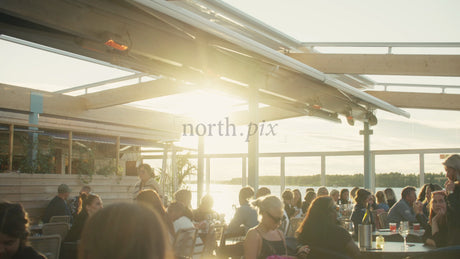 Summer Evening on a Rooftop Patio in Lulea, Sweden: Friends and Family Enjoying Drinks and Conversation